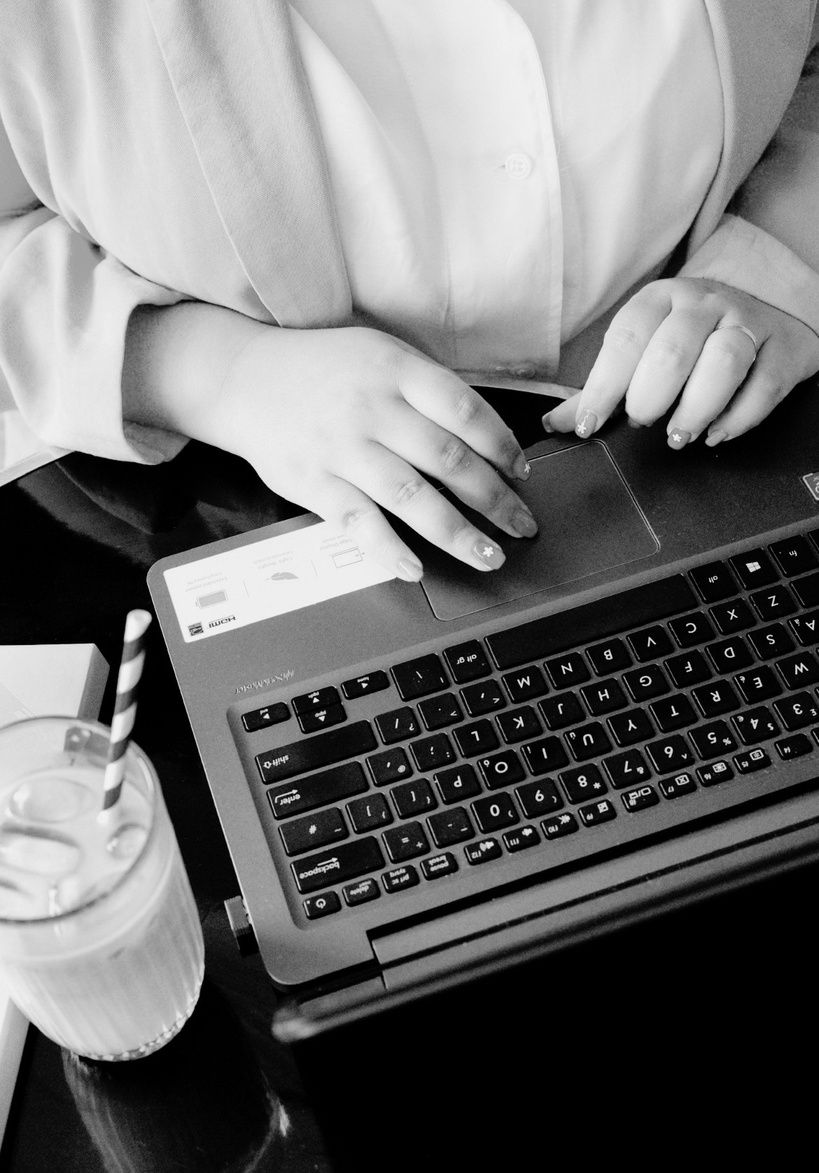 Hands working on a laptop
